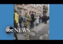 Ukrainians wait in line to buy stamps featuring soldier l ABC News